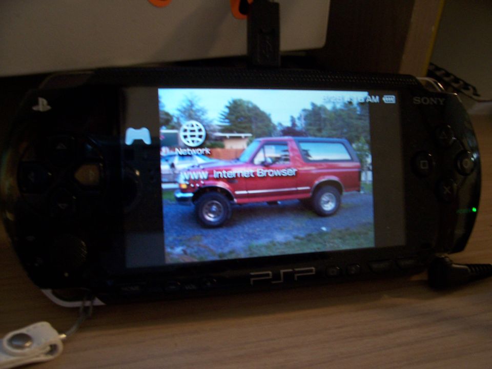 Red 1995 Ford Bronco side view displayed on a PSP screen