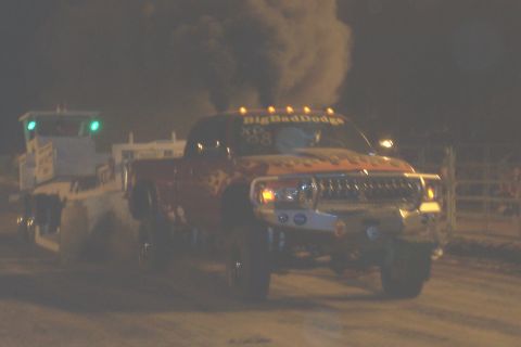1994 Ford F-150 - A Dodge pickup truck emits a large cloud of dark smoke while pulling a trailer at night.
