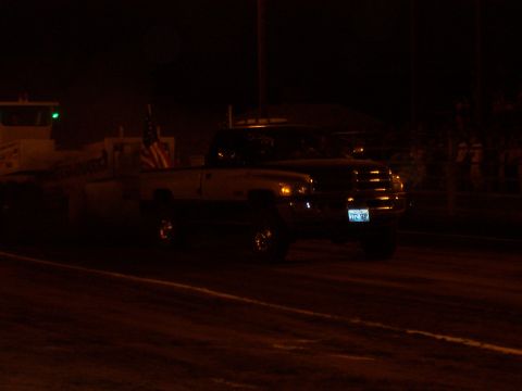 1994 Ford F-150 - A Dodge Ram pickup truck is seen at night, pulling a trailer and displaying an American flag.