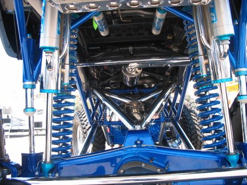 1986 Ford Bronco - Underside view of a heavily modified vehicle's suspension system.