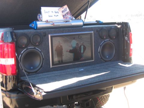 1986 Ford Bronco - This truck bed has been outfitted with a custom entertainment system a large screen and numerous speakers.