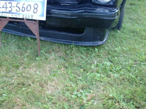 1978 Ford Mustang II - Close-up of a black car's front bumper and a license plate holder.
