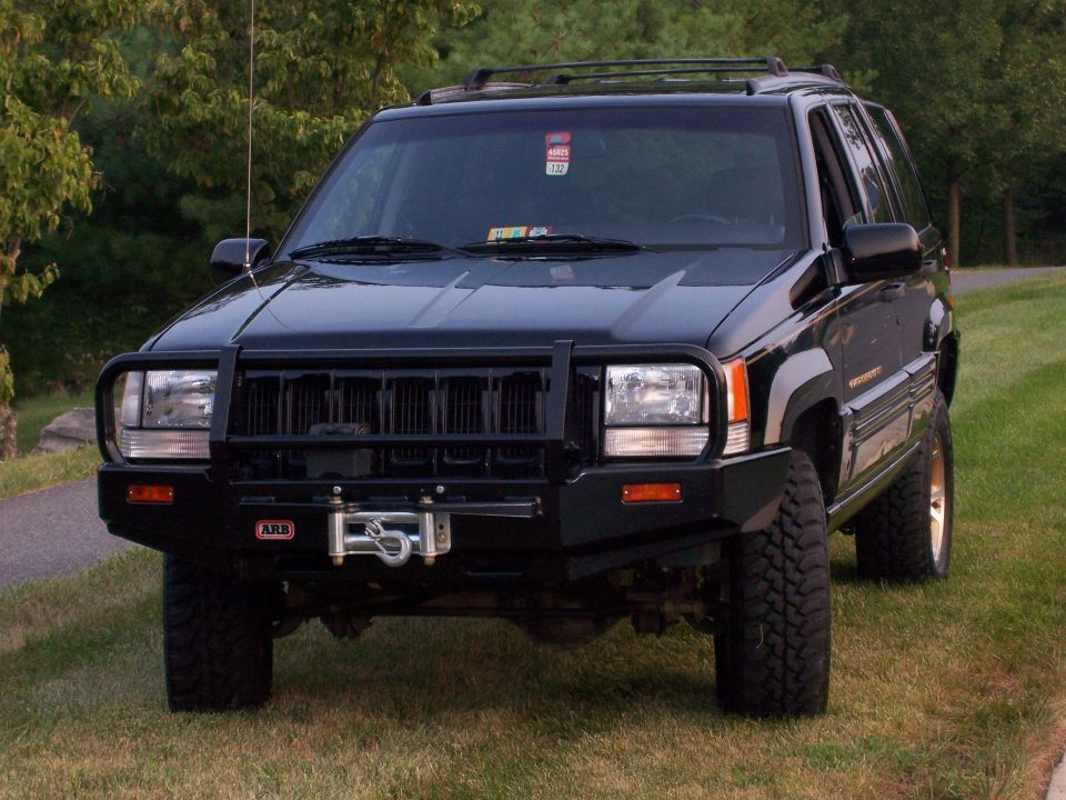 1996 Jeep Grand Cherokee with ARB bull bar and winch, parked on grass