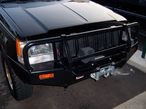 1996 Jeep Grand Cherokee - This black 1996 Jeep Grand Cherokee features a custom bull bar and winch for off-road use.