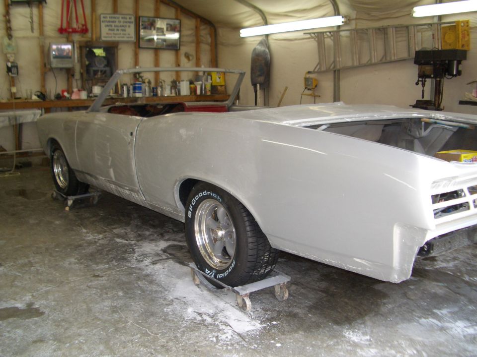 1967 Pontiac GTO convertible in primer on dollies, rear 3/4 view