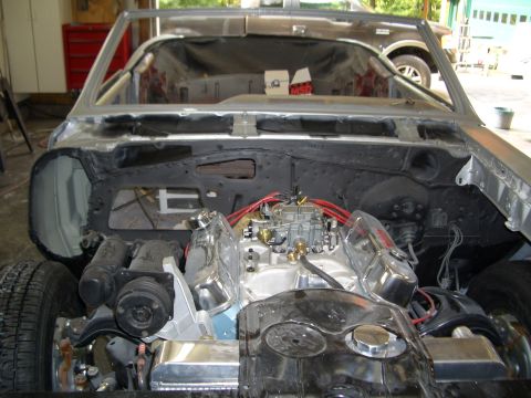 1967 Pontiac GTO - The engine bay of a car undergoing restoration, showing the V8 engine and associated components.