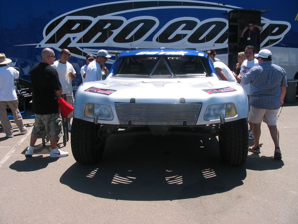 Front view of a custom off-road truck with a silver grille and blue accents