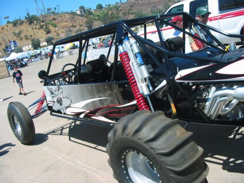 1986 Ford Bronco - A custom sand rail buggy is parked outdoors, with a white pickup truck visible behind it.