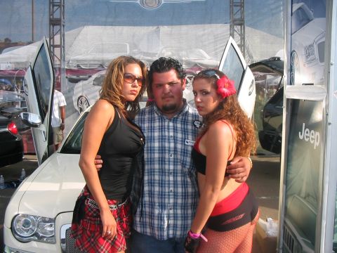 1986 Ford Bronco - A man and two women pose for a photo at an outdoor car show event.
