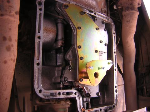 1984 Ford Bronco - Close-up view of a transmission's deep pan installation, highlighting the gasket and hardware.