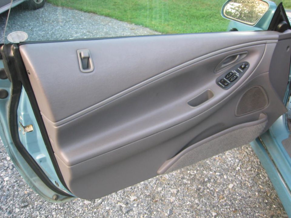 Car door panel with window controls and speaker grille