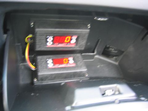 1993 Ford Probe - Aftermarket digital gauges are installed in the glove compartment of a vehicle.