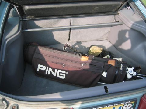 1993 Ford Probe - The trunk of a car contains a PING golf bag and clubs.