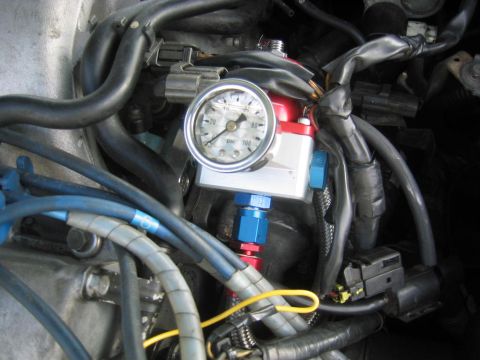 1993 Ford Probe - Close-up of an aftermarket fuel pressure regulator with a gauge, indicating 60 PSI.