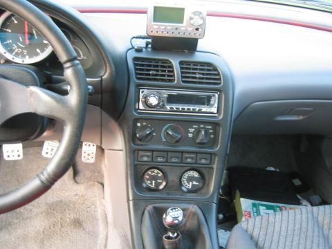 1993 Ford Probe - Interior view of a 1993 Ford Probe, a custom gauge setup and manual shifter.