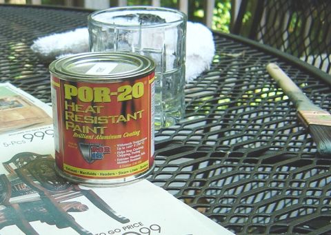 1986 Ford Bronco - A can of POR-20 heat resistant paint sits on a table next to a glass of water and a paintbrush, suggesting a DIY project.