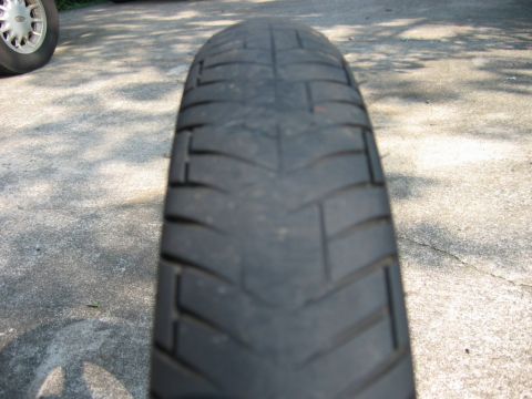 1985 Ford Crown Victoria LTD - The tread on this tire is significantly worn down, showing the underlying construction.