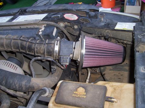 1998 Ford Ranger - Aftermarket K&N cold air intake installed in the engine bay, connected to the mass airflow sensor.