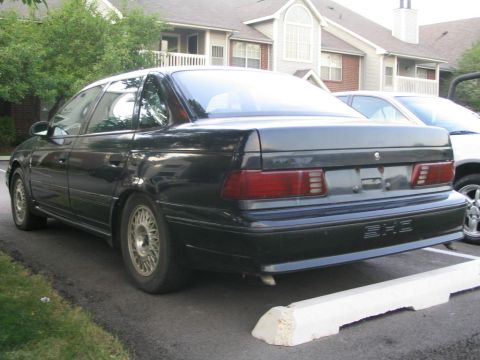 1990 Ford Taurus - Rear view of a black 1990 Ford Taurus SHO parked in a lot.