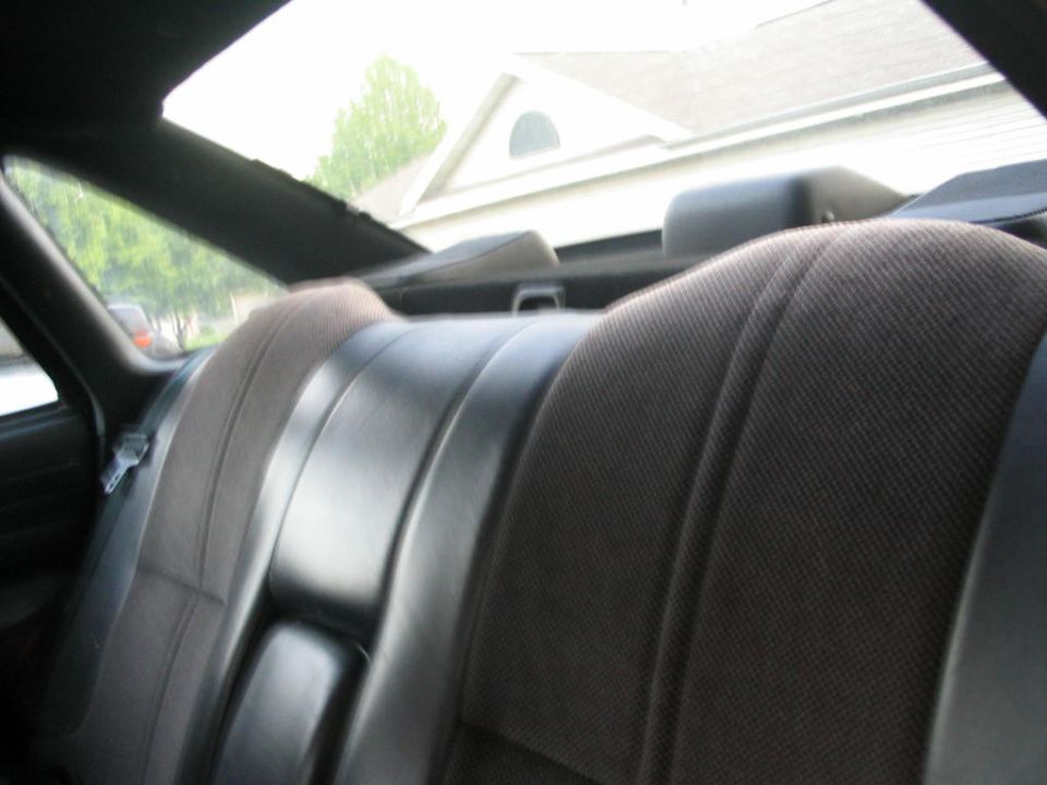 Rear seats of a car, showing fabric and leather upholstery