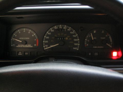 1990 Ford Taurus - The interior of a 1990 Ford Taurus displays its instrument cluster, including the speedometer and tachometer.