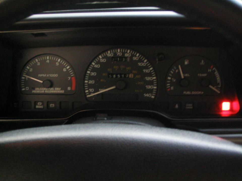 Vehicle instrument cluster showing tachometer, speedometer and odometer 56512