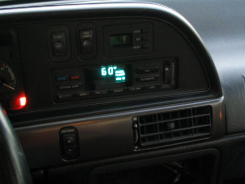 1990 Ford Taurus - Interior view of a car's dashboard, displaying climate control settings and various buttons.