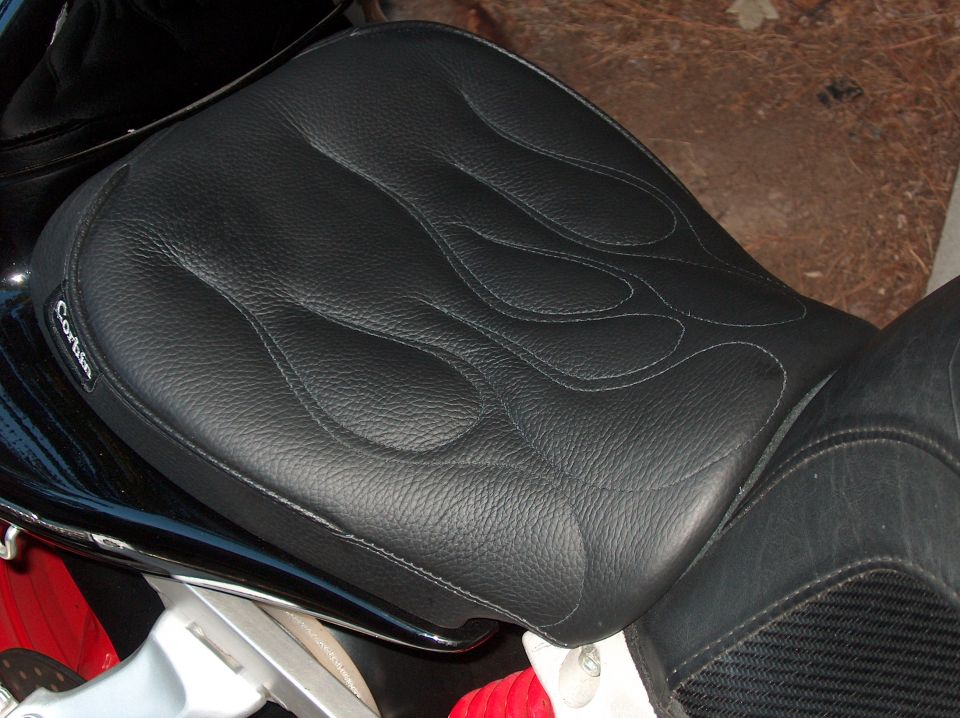 Black Corbin motorcycle seat with flame stitching, close-up side view