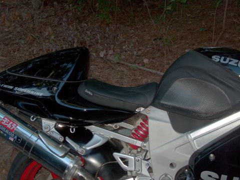 2002 Suzuki TL1000R - Side view of a black 2002 Suzuki TL1000R motorcycle a Corbin seat and Yoshimura exhaust.