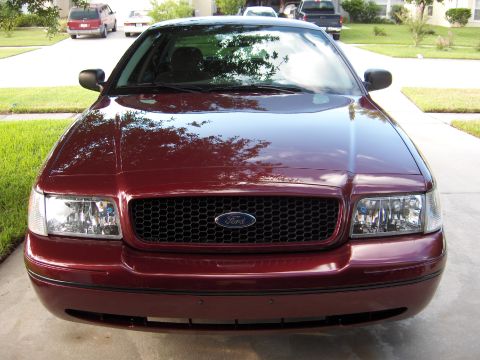 2004 Ford Crown Victoria - Front view of a maroon 2004 Ford Crown Victoria parked on a driveway.