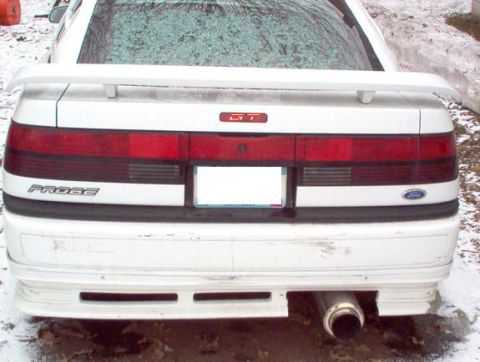 1996 Ford Probe - Rear view of a white Ford Probe GT, showing the spoiler and distinctive taillight bar.