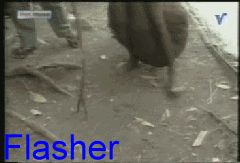 2000 Isuzu Rodeo - A scene shows people walking on a debris-strewn ground, with the word "Flasher" overlaid in blue text.