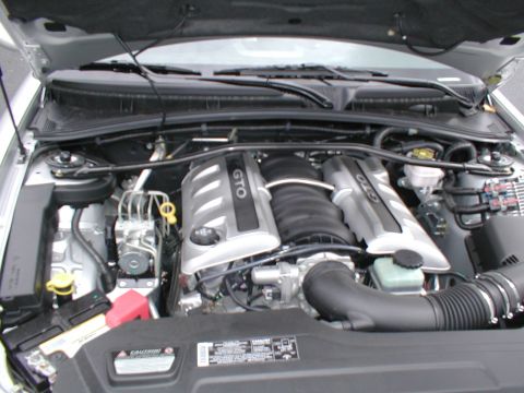 1979 Ford Bronco - The engine bay features GTO branded valve covers, indicating a Pontiac GTO model, not a 1979 Ford Bronco.