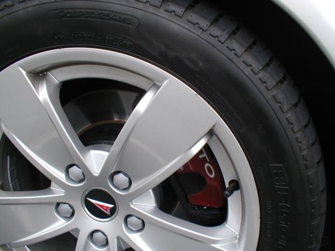 1979 Ford Bronco - Close-up of a silver wheel with a red brake caliper that has 'GTO' written on it.