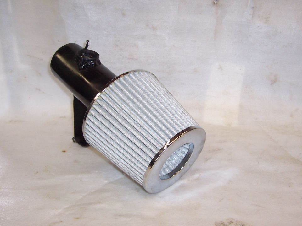Black short-ram intake pipe with chrome-capped cone air filter on white backdrop