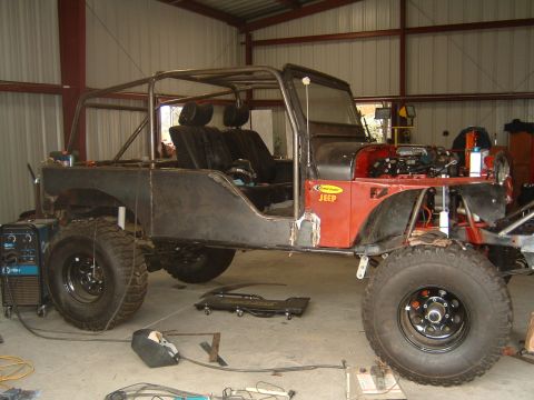 1964 Jeep CJ5 - This 1964 Jeep CJ5 is undergoing a build-up, a custom roll cage and exposed engine components.