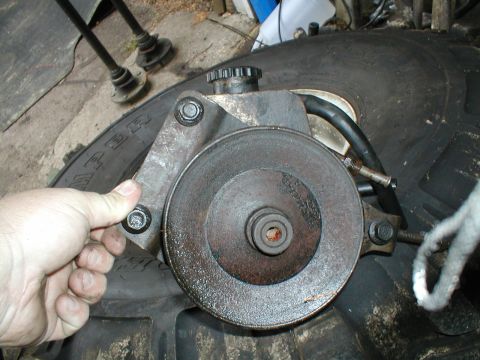 1979 Ford Bronco - A close-up view of a power steering pump, likely removed from a vehicle for repair or replacement.