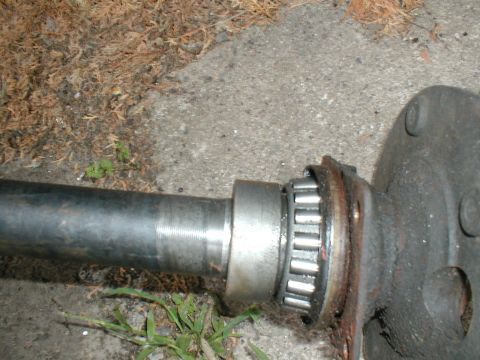 1979 Ford Bronco - Close-up of an axle shaft with a roller bearing and flange, likely a replacement part.
