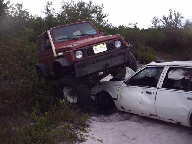 Red off-road vehicle on white sedan, front bumper damaged, license plate RB-558