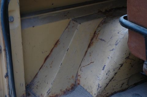 1972 Ford Bronco - The interior cargo area shows significant rust on the yellow painted metal panels.