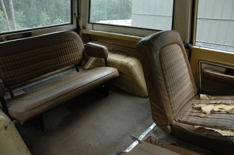 1972 Ford Bronco - Interior view of a 1972 Ford Bronco, highlighting the worn brown seats and interior panels.