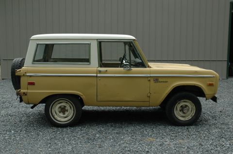 1972 Ford Bronco - This 1972 Ford Bronco is seen from the side, a two-tone yellow and white color scheme and a spare tire mounted on the rear.