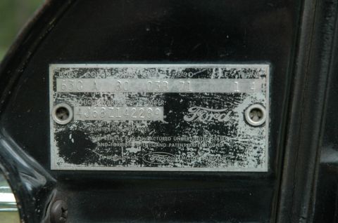 1964 Ford Galaxie - A close-up view of a Ford vehicle identification plate, showing various codes and the Ford logo.