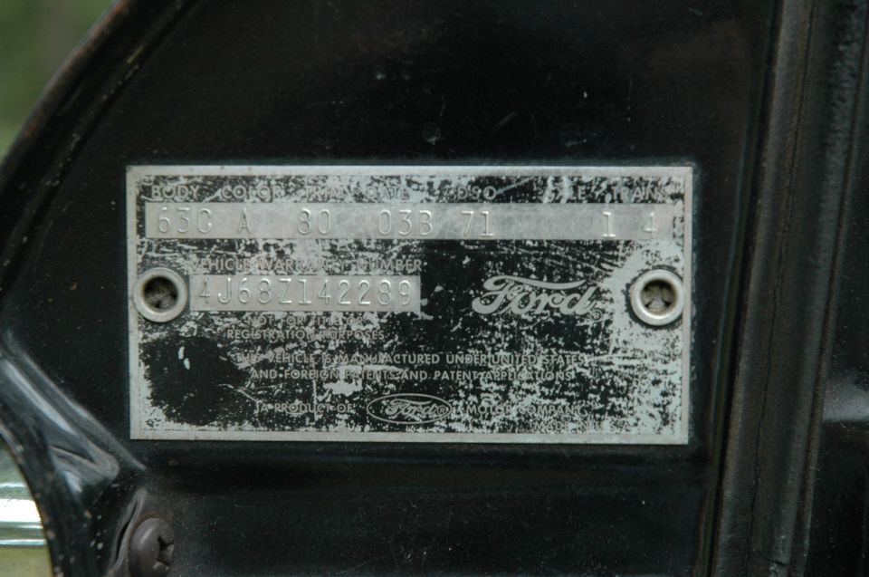 Ford warranty plate on a black door jamb with body, color, trim and date codes