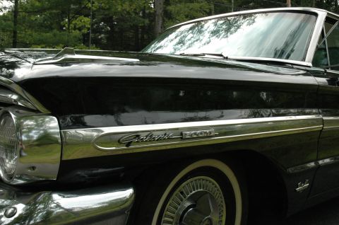 1964 Ford Galaxie - Close-up of the "Galaxie 500XL" emblem on a black 1964 Ford Galaxie.