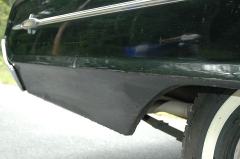 1964 Ford Galaxie - Side view of the rear quarter panel on a 1964 Ford Galaxie, showing the chrome trim and black rocker molding.