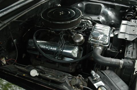 1964 Ford Galaxie - The engine bay of a 1964 Ford Galaxie features chrome valve covers and a prominent air cleaner assembly.