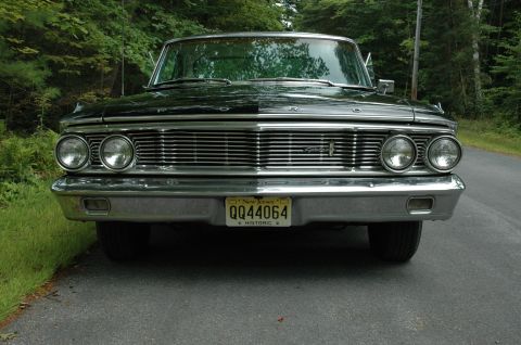 1964 Ford Galaxie - Front view of a 1964 Ford Galaxie parked on a road with trees in the background.