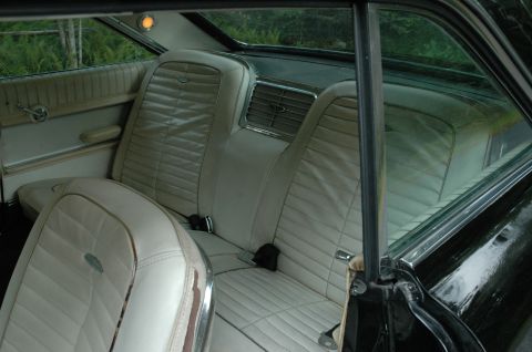1964 Ford Galaxie - Rear interior of a 1964 Ford Galaxie 500XL, beige pleated upholstery and chrome accents.