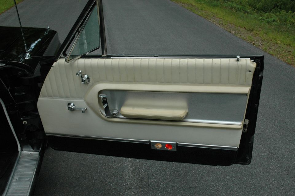 1964 Ford Galaxie interior door panel with beige upholstery and chrome accents